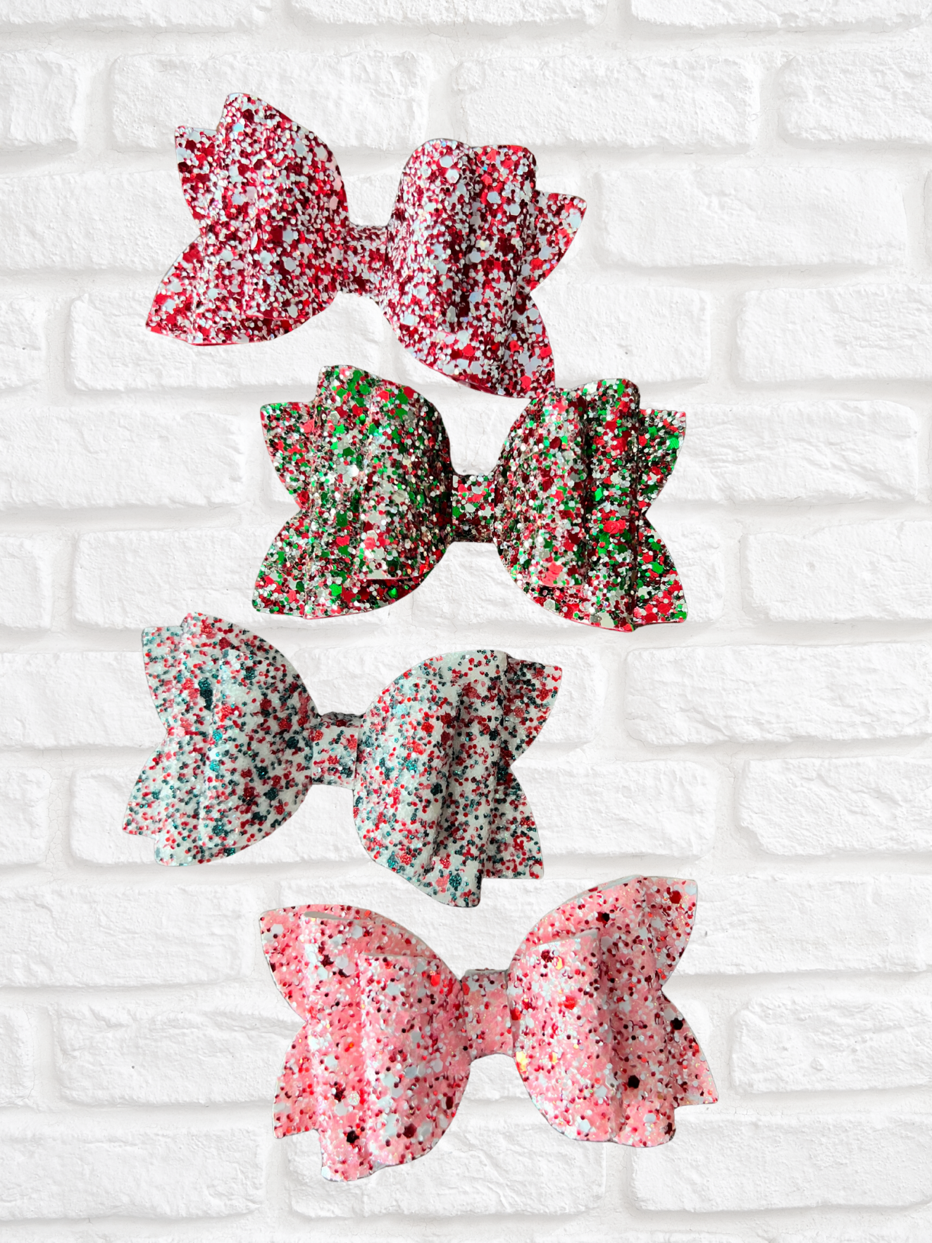 Set of floral-patterned hair bows on a white brick background