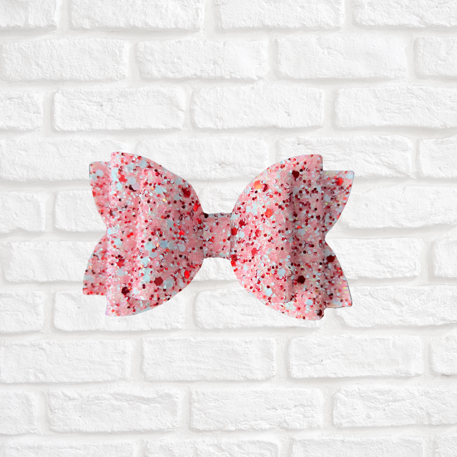 Pink and white floral bow on a white brick wall background